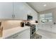 White kitchen features gas range, ample counter space, and built-in microwave at 8112 Slipway Dr, Sarasota, FL 34240