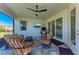 Relaxing covered patio with seating area and ceiling fan at 8112 Slipway Dr, Sarasota, FL 34240