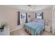 Bright bedroom with striped bedspread and ceiling fan at 881 Polaris Rd, Venice, FL 34293