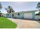 Light blue ranch home with a well-maintained lawn and walkway at 881 Polaris Rd, Venice, FL 34293