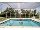 Refreshing blue pool with a red floatie, surrounded by a screen enclosure at 881 Polaris Rd, Venice, FL 34293