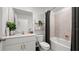 Bathroom with white vanity, bathtub, and gray shower curtain at 9100 Tequila Sunrise Dr, Sarasota, FL 34241