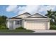 One-story home with gray siding, two-car garage, and landscaping at 9100 Tequila Sunrise Dr, Sarasota, FL 34241