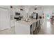 Bright kitchen with white cabinets, large island, and view to entryway at 9100 Tequila Sunrise Dr, Sarasota, FL 34241