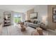 Living room with gray sofa, wooden coffee table, and access to backyard at 9100 Tequila Sunrise Dr, Sarasota, FL 34241