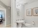 Small half bathroom with pedestal sink and toilet at 9203 Griggs Rd # D103, Englewood, FL 34224