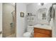 Clean bathroom with shower, toilet and wooden vanity at 9203 Griggs Rd # D103, Englewood, FL 34224