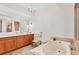 Elegant bathroom with double vanity, soaking tub, and separate shower at 9203 Griggs Rd # D103, Englewood, FL 34224