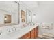 Bathroom boasts a double vanity, large mirror, and a separate shower and tub at 9203 Griggs Rd # D103, Englewood, FL 34224