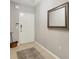 Small entryway with tiled floor and a mirror at 9203 Griggs Rd # D103, Englewood, FL 34224