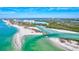 Aerial view of coastal community with waterfront homes and lush greenery at 9393 Midnight Pass Rd # 704, Sarasota, FL 34242