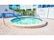 Relaxing hot tub with easy access from pool area at 9393 Midnight Pass Rd # 704, Sarasota, FL 34242