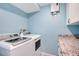 Convenient laundry room with washer, dryer, and granite countertop at 9393 Midnight Pass Rd # 704, Sarasota, FL 34242