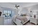 Spacious main bedroom with water views and white furnishings at 9393 Midnight Pass Rd # 704, Sarasota, FL 34242