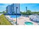 Community pool and hot tub with tennis court and building view at 9393 Midnight Pass Rd # 704, Sarasota, FL 34242