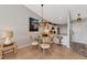 Bright dining area with glass table and four chairs, adjacent to kitchen at 941 Waterside Ln, Bradenton, FL 34209