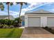 Two-car garage with a landscaped front yard at 941 Waterside Ln, Bradenton, FL 34209