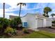 White house with two-car garage, landscaped yard, and blue gate at 941 Waterside Ln, Bradenton, FL 34209