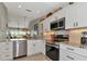 Modern kitchen featuring stainless steel appliances and granite countertops at 941 Waterside Ln, Bradenton, FL 34209