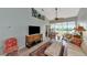 Living room with large TV, comfy seating, and access to screened balcony at 941 Waterside Ln, Bradenton, FL 34209