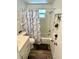 Updated bathroom with a tub/shower combo, vanity, and modern flooring at 970 S Allendale Ave, Sarasota, FL 34237