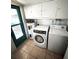 Functional laundry room complete with washer, dryer, and ample storage at 970 S Allendale Ave, Sarasota, FL 34237