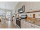 Modern kitchen with stainless steel appliances and granite counters at 1219 Spoonbill Landings Cir, Bradenton, FL 34209