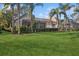 Landscaped backyard with lush lawn and screened patio at 12204 Thornhill Ct, Lakewood Ranch, FL 34202