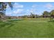 Golf course view with houses and pond in background at 12204 Thornhill Ct, Lakewood Ranch, FL 34202