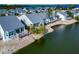Aerial view of waterfront homes with private docks and lush landscaping at 1229 Spoonbill Landings Cir, Bradenton, FL 34209