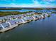 Aerial view of community, showcasing waterfront location and numerous homes at 1229 Spoonbill Landings Cir, Bradenton, FL 34209