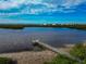 Elevated view of a dock extending over calm water at 1229 Spoonbill Landings Cir, Bradenton, FL 34209