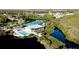 Resort-style pool and clubhouse with surrounding nature at 1229 Spoonbill Landings Cir, Bradenton, FL 34209