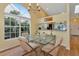 Dining area with glass table, chairs, and view to the kitchen at 1229 Spoonbill Landings Cir, Bradenton, FL 34209