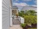Backyard access with a wrought-iron gate and lush green landscaping at 1229 Spoonbill Landings Cir, Bradenton, FL 34209