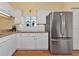 White cabinets, granite counters, and stainless steel refrigerator at 1229 Spoonbill Landings Cir, Bradenton, FL 34209