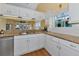 Kitchen with granite countertops, double sink, and white cabinets at 1229 Spoonbill Landings Cir, Bradenton, FL 34209