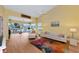 Living area with vaulted ceiling, seating, and access to balcony at 1229 Spoonbill Landings Cir, Bradenton, FL 34209