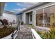 Stone patio with seating area and view into the bright kitchen at 1229 Spoonbill Landings Cir, Bradenton, FL 34209