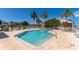 Community pool with ample deck space, lounge chairs, and brick pavers at 1229 Spoonbill Landings Cir, Bradenton, FL 34209