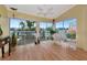 Bright sunroom with wood floors, deck access, and relaxing seating at 1229 Spoonbill Landings Cir, Bradenton, FL 34209