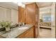 Bathroom with granite countertop, modern vanity, and a view into the bedroom at 1243 Siesta Bayside Dr # D, Sarasota, FL 34242