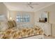 Main bedroom with king-size bed and ceiling fan at 1243 Siesta Bayside Dr # D, Sarasota, FL 34242