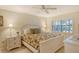 Main bedroom with king-size bed and ceiling fan at 1243 Siesta Bayside Dr # D, Sarasota, FL 34242