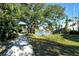 Walking path alongside pond with lush tropical landscaping at 1243 Siesta Bayside Dr # D, Sarasota, FL 34242