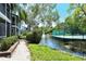 Peaceful waterfront walkway with pond and lush landscaping at 1243 Siesta Bayside Dr # D, Sarasota, FL 34242