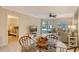 Dining area with glass-top table and view of the main bedroom at 1243 Siesta Bayside Dr # D, Sarasota, FL 34242