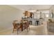 Kitchen features a breakfast bar and a dining area with glass table at 1243 Siesta Bayside Dr # D, Sarasota, FL 34242