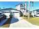 Exterior view of a charming two-story home with attached garage and lush landscaping at 1243 Siesta Bayside Dr # D, Sarasota, FL 34242