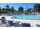 Inviting community pool with plenty of lounge chairs at 1243 Siesta Bayside Dr # D, Sarasota, FL 34242